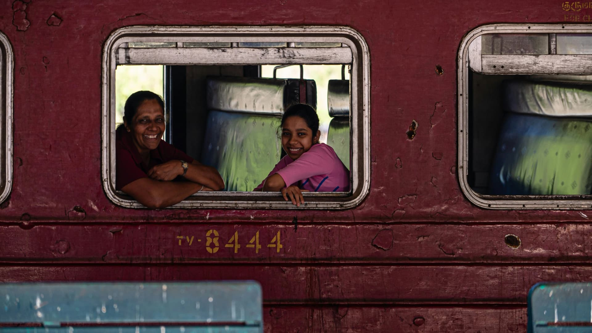 Mother and daughter smiling on a train